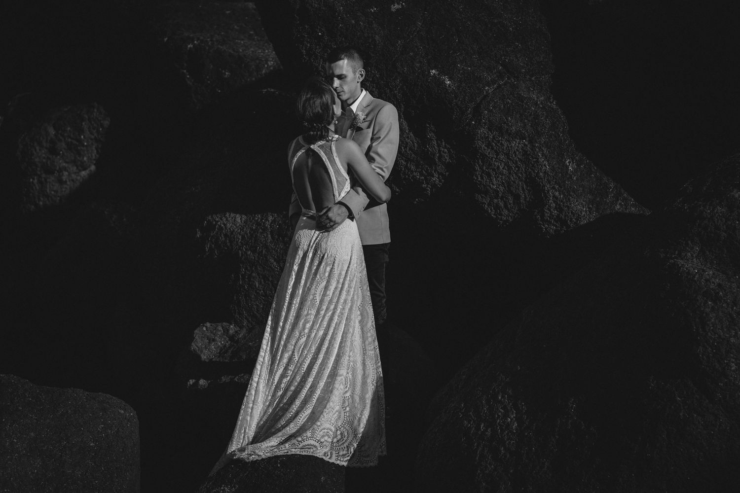 Dramatic black and white wedding portrait captured in dark cave setting.Gold Coast beach wedding photography. Froggies beach