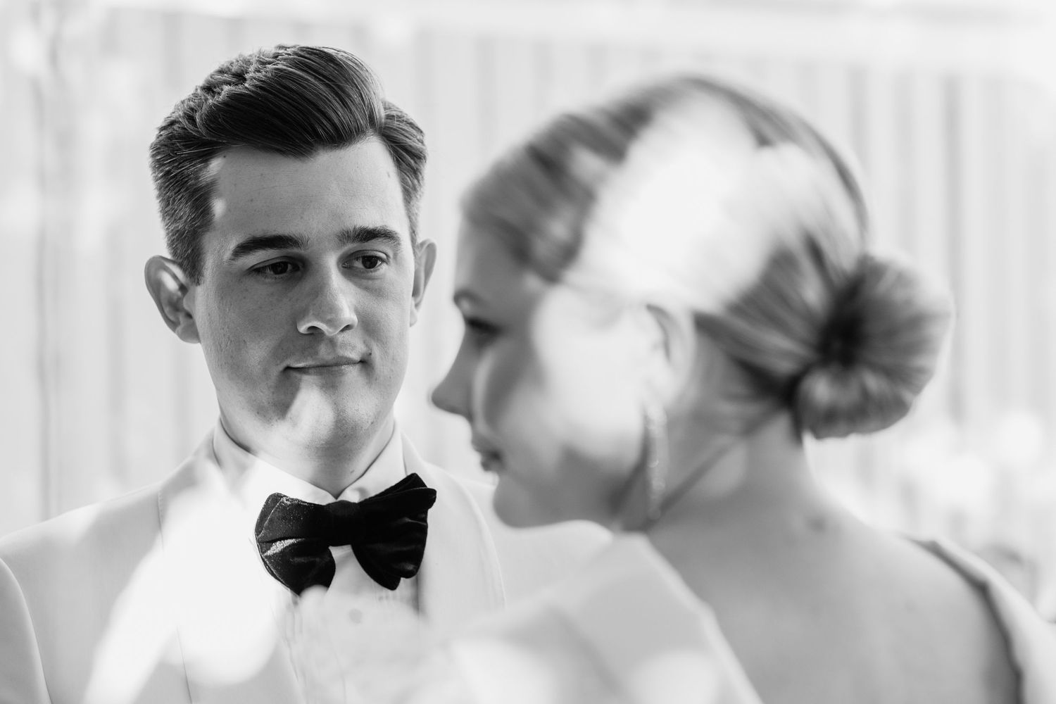 Wedding guests seated in formal attire during an elegant ceremony.