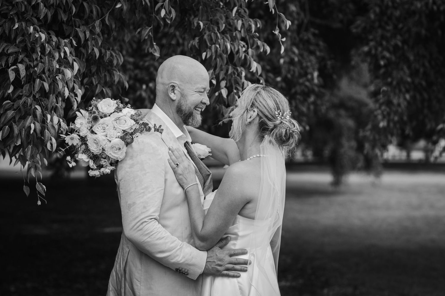Intimate black and white moment captured between couple in garden setting.New farm park wedding photos in Brisbane