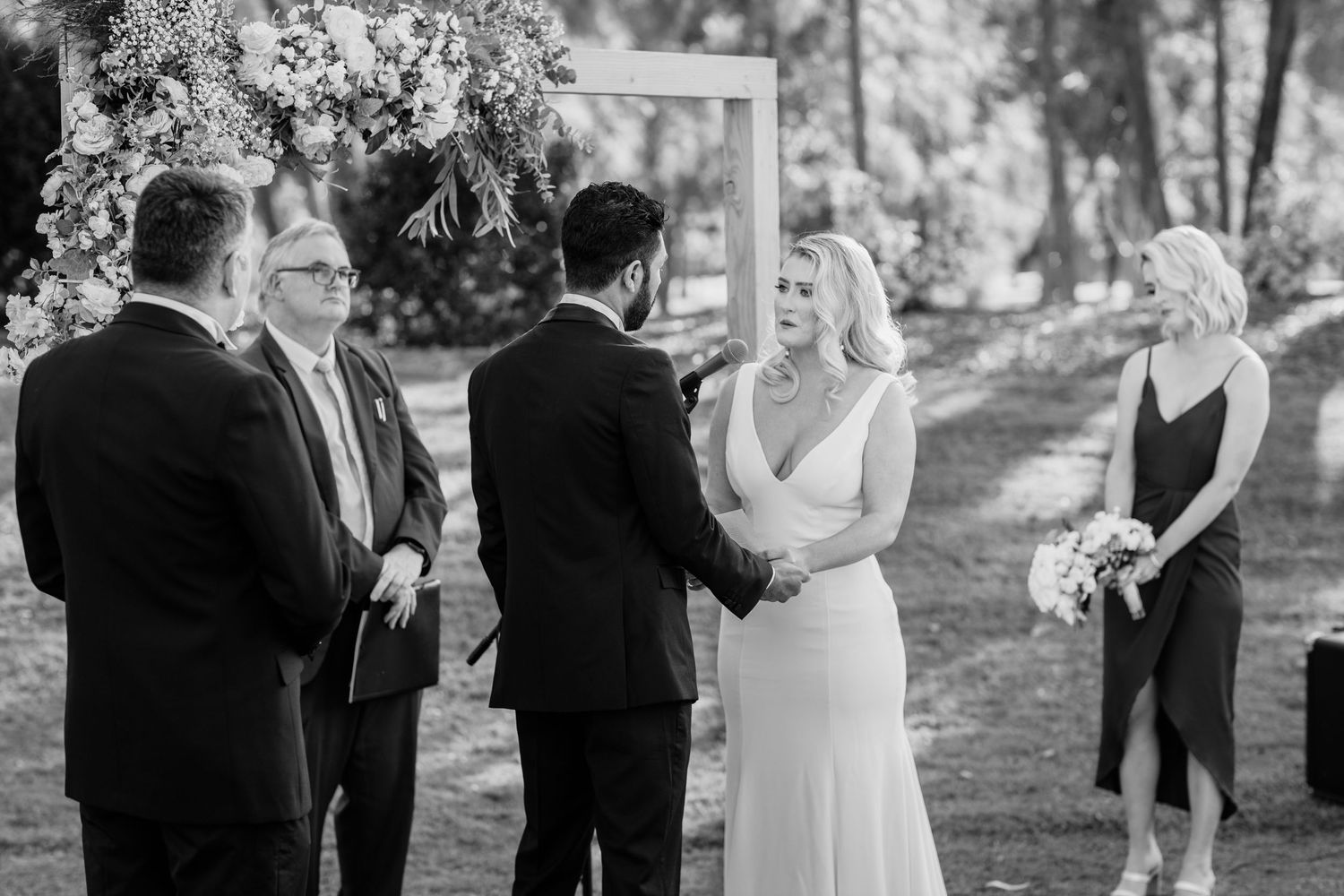 Wedding party gathered outdoors in a garden setting during a sunny afternoon celebration. Surfers Paradise Golf Club wedding. Surfers Paradi