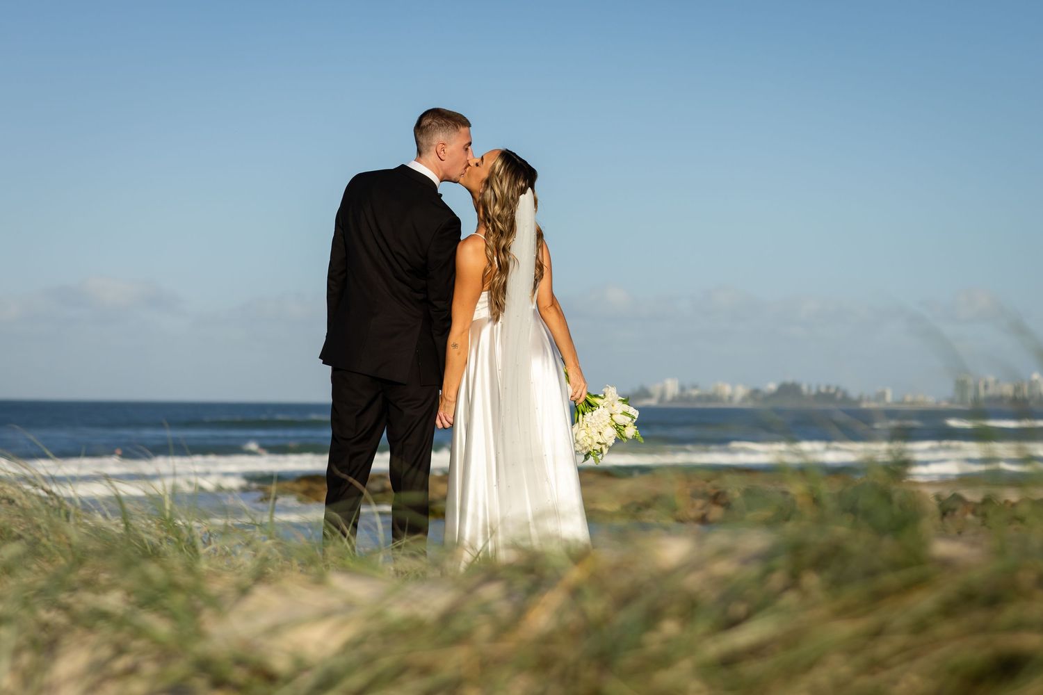 Intimate wedding moments captured against a coastal backdrop.beach wedding currumbin surf club wedding