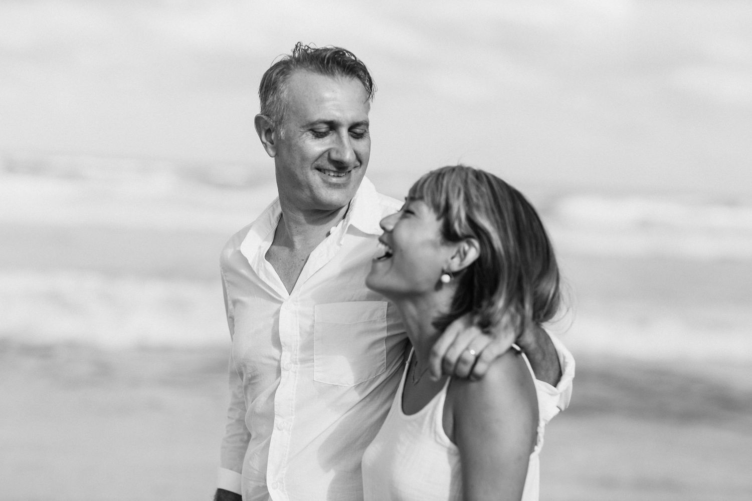 Black and white beach portraits showing tender family interactions.Gold Coast candid family photographer.