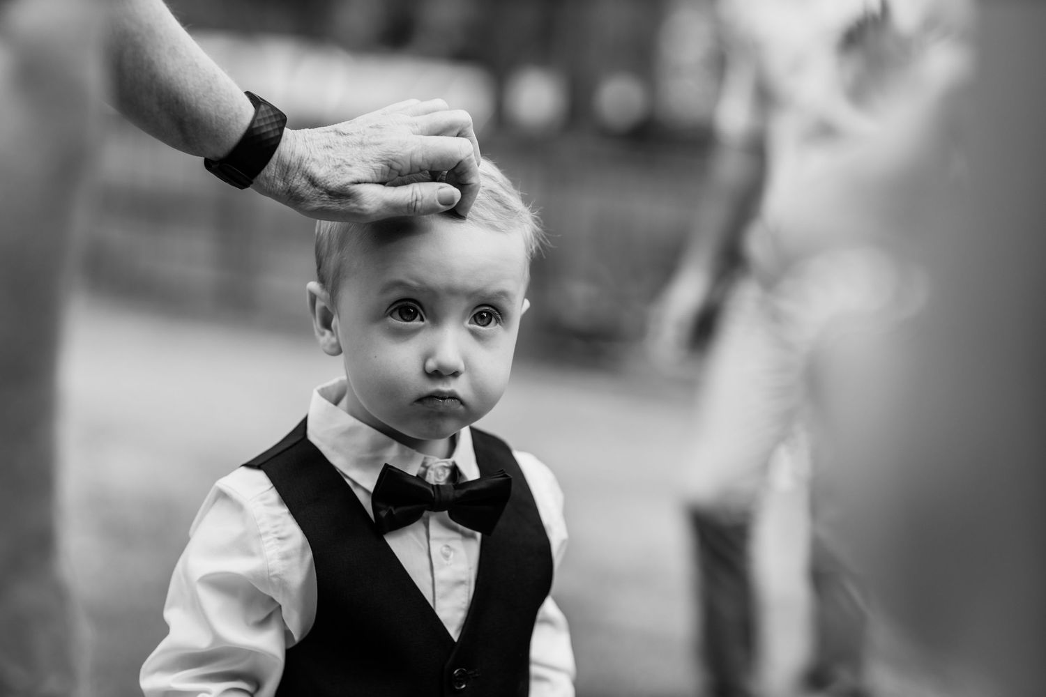 Black and white candid moments from a formal wedding celebration.