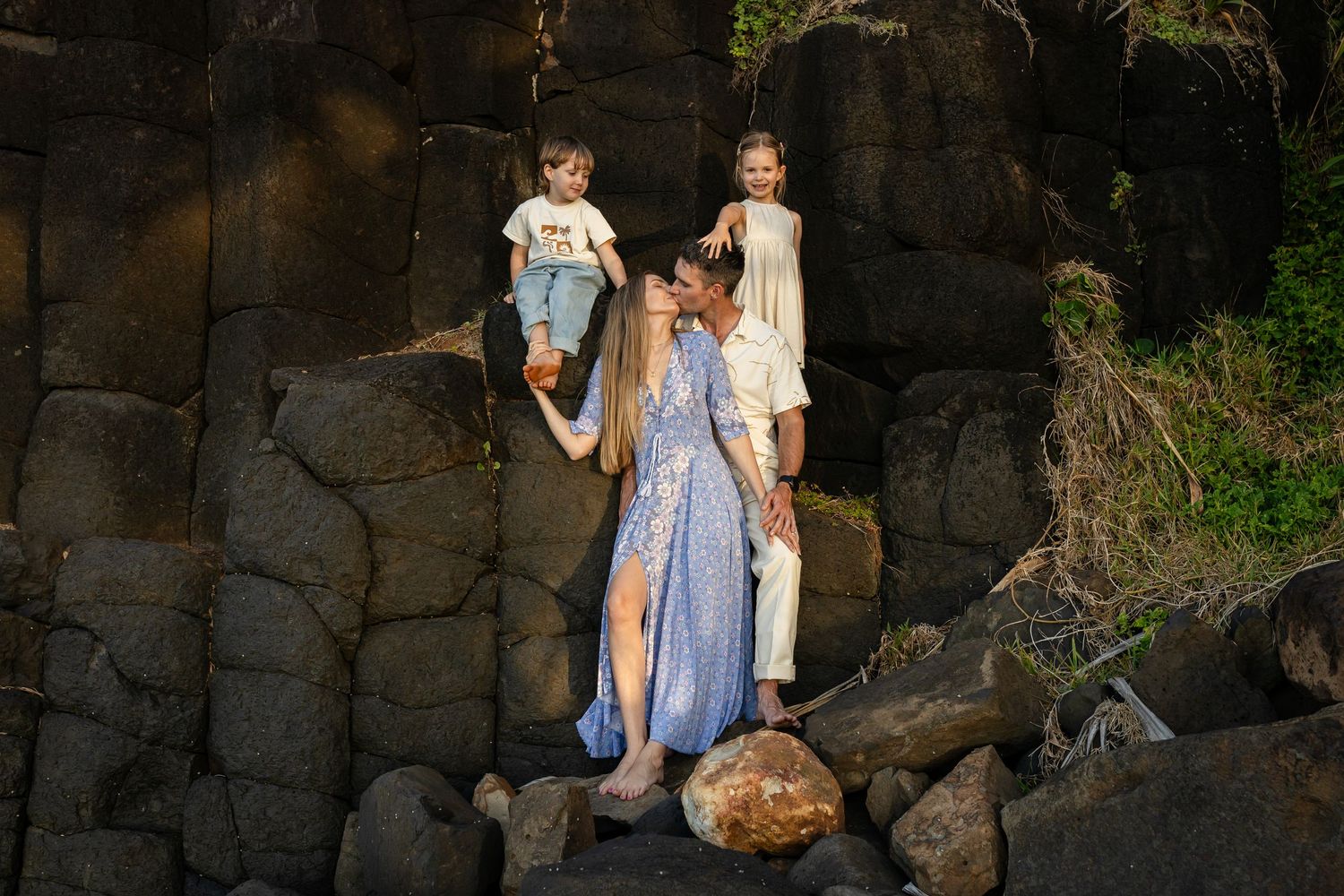 Stone wall backdrop creates dramatic natural setting at dusk.Gold Coast candid family photographer.