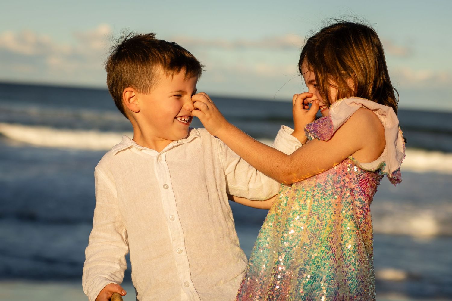 Golden hour beach portraits with sparkling dress against ocean backdrop.Family photography cabarita New South Wales Cabarita headland