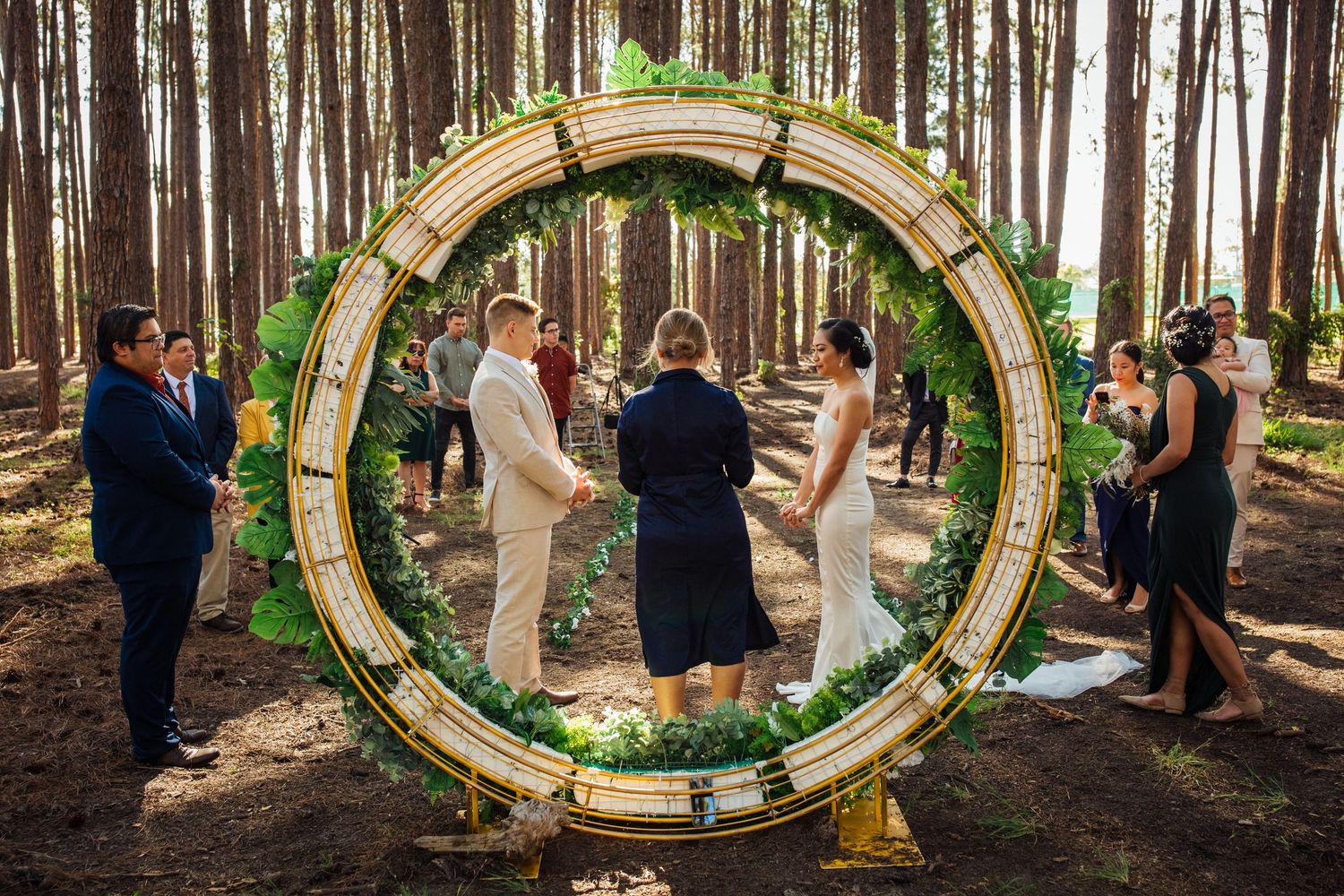 Decorative circular wedding arch frames the couple during their forest ceremony.pizzey park wedding Gold Coast