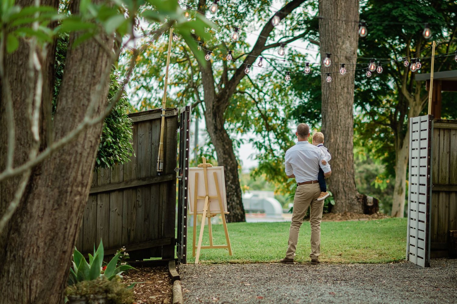 Garden wedding venue with tall trees and natural landscaping.