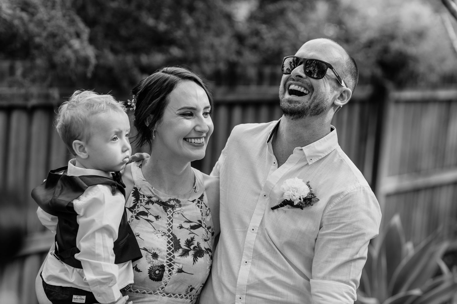 Black and white candid portrait of a happy family moment outdoors.Gold Coast elopement photographer