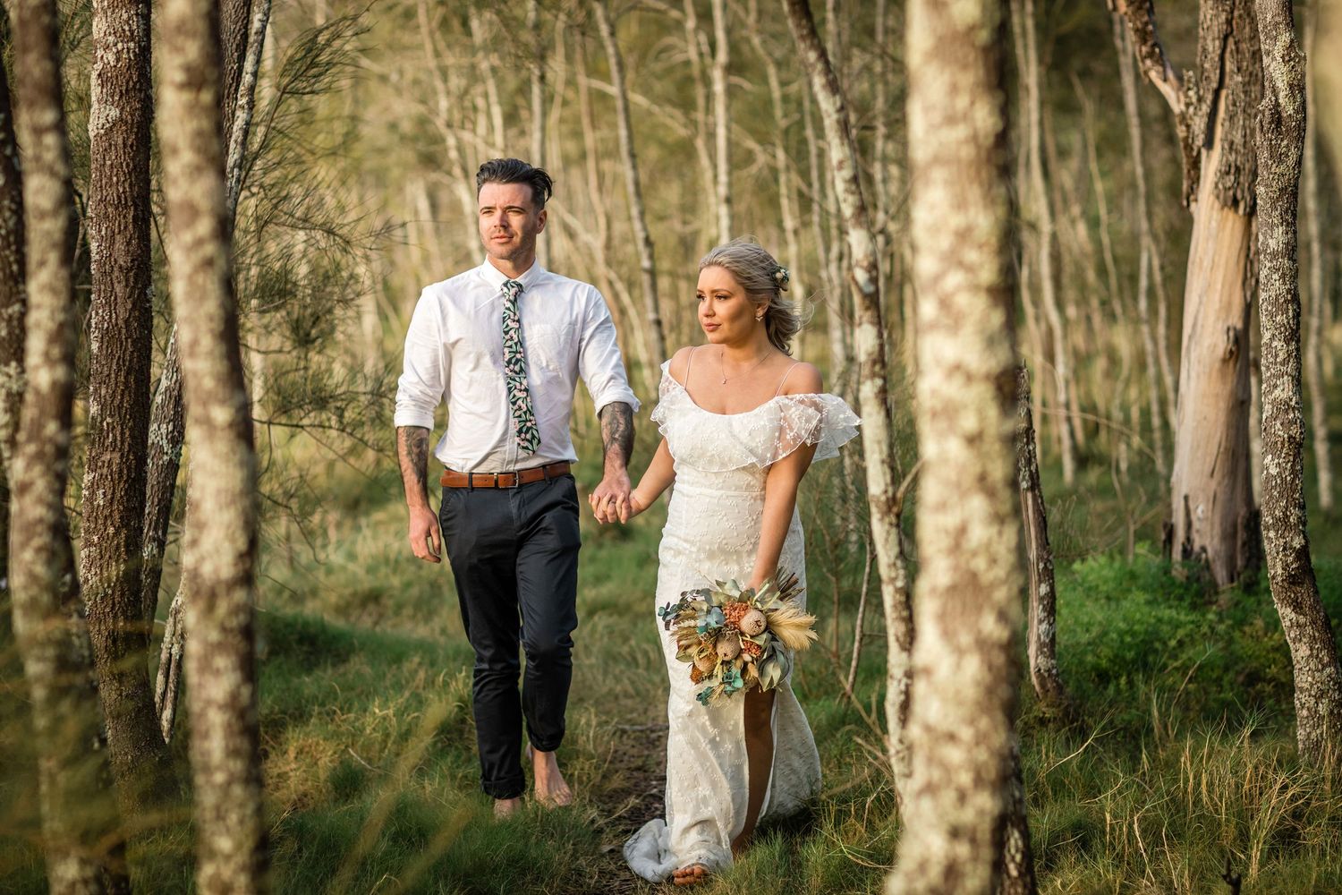 Couple walking through a serene birch forest during golden hour.  Tugun beach wedding Currumbin beach wedding