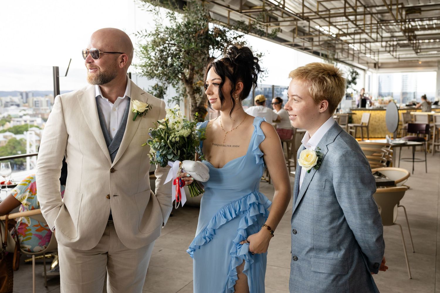 Wedding celebration on a covered outdoor terrace with modern furnishings.