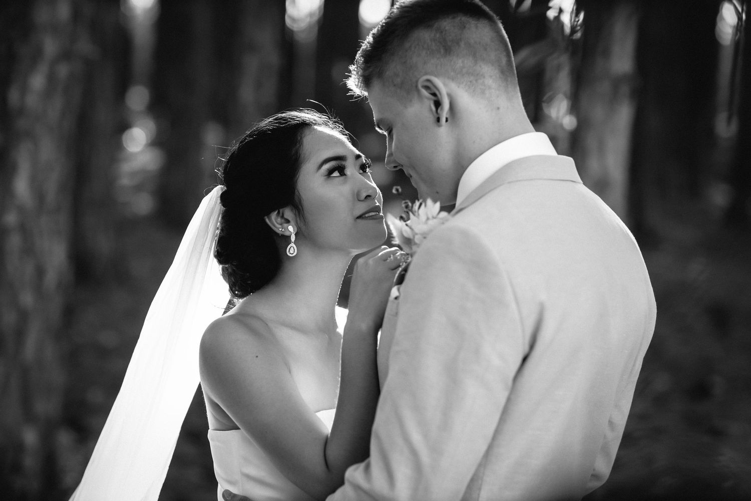 Intimate black and white photo of couple sharing tender moment in woods.pizzey park wedding Gold Coast