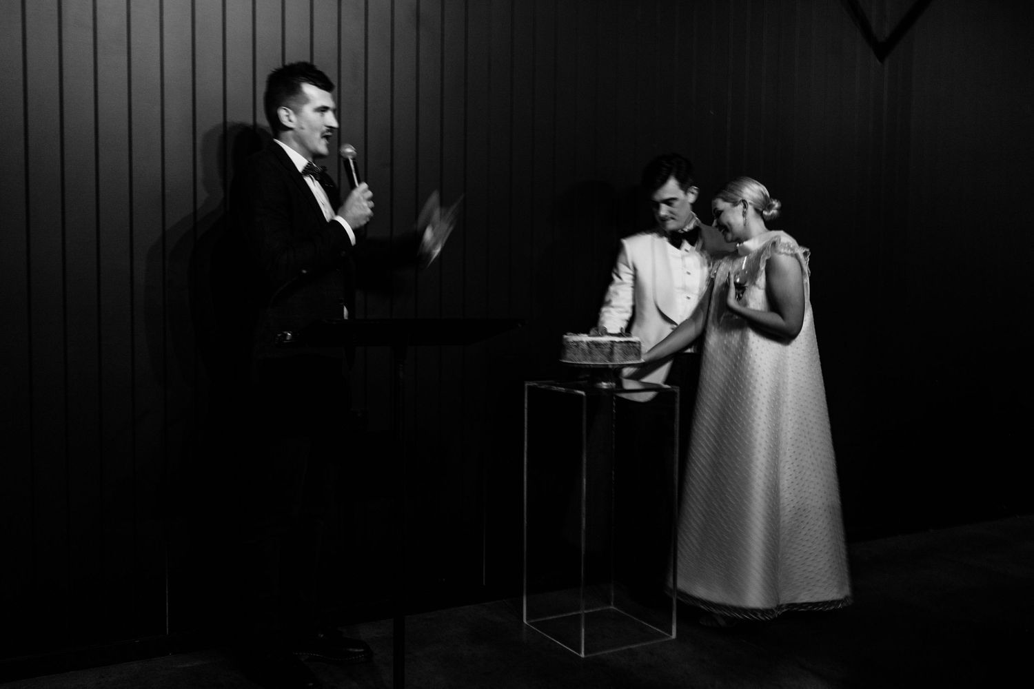 Black and white photo of an intimate wedding ceremony moment.