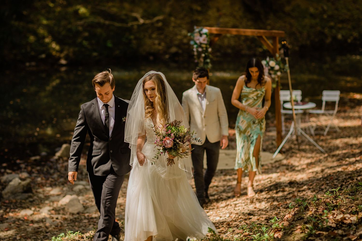 Wedding party walking through autumn forest after ceremony.Currumbin Valley wedding photography Gold Coast