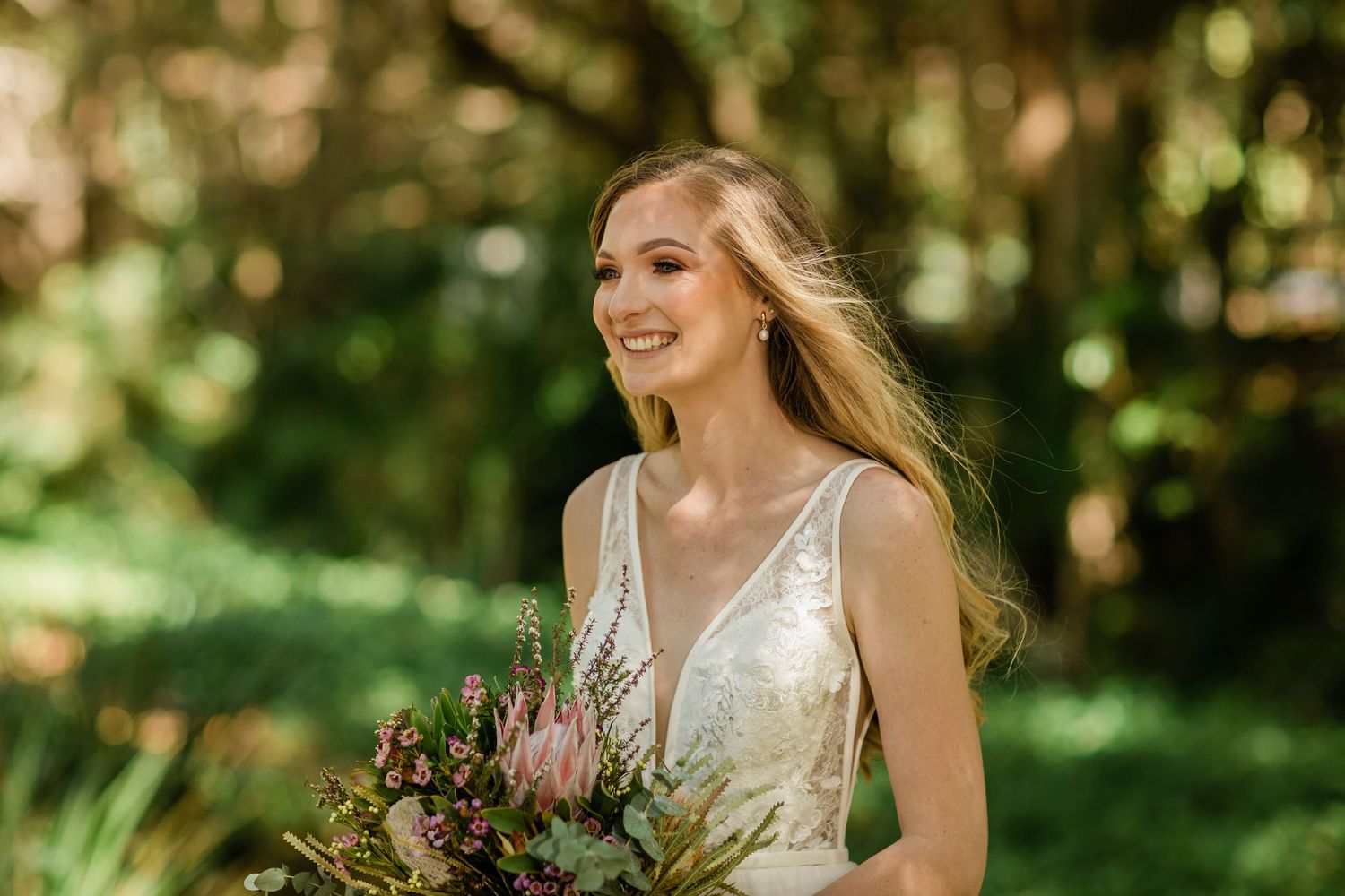 A joyful moment captured in a garden wedding photoshoot with natural lighting and green foliage.Gold Coast beach wedding photography