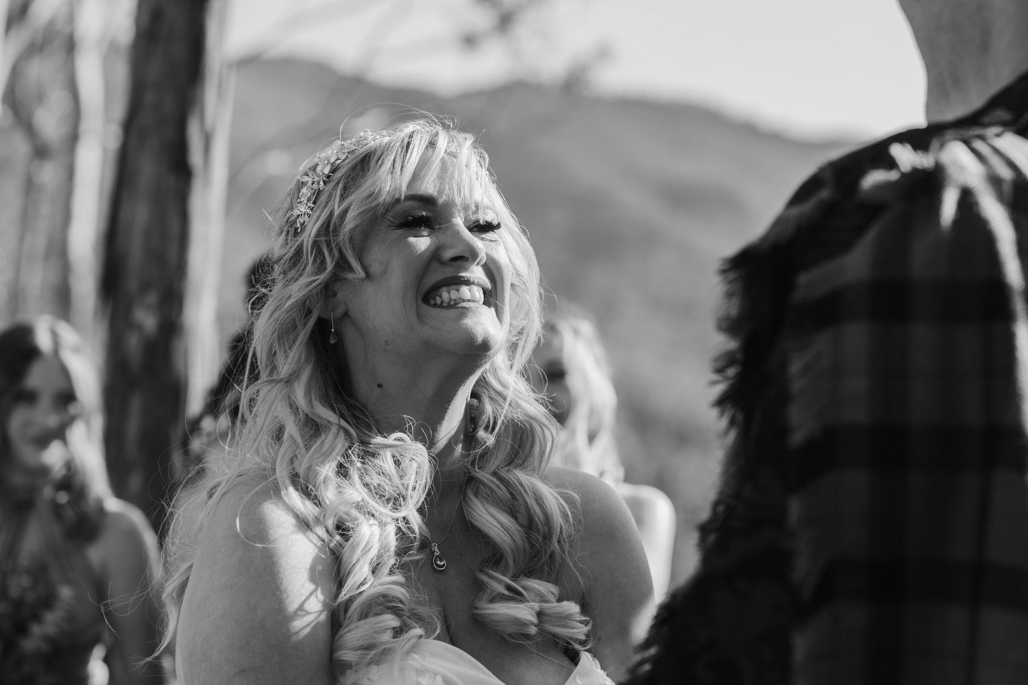 Black and white wedding moments captured during an outdoor mountain ceremony.