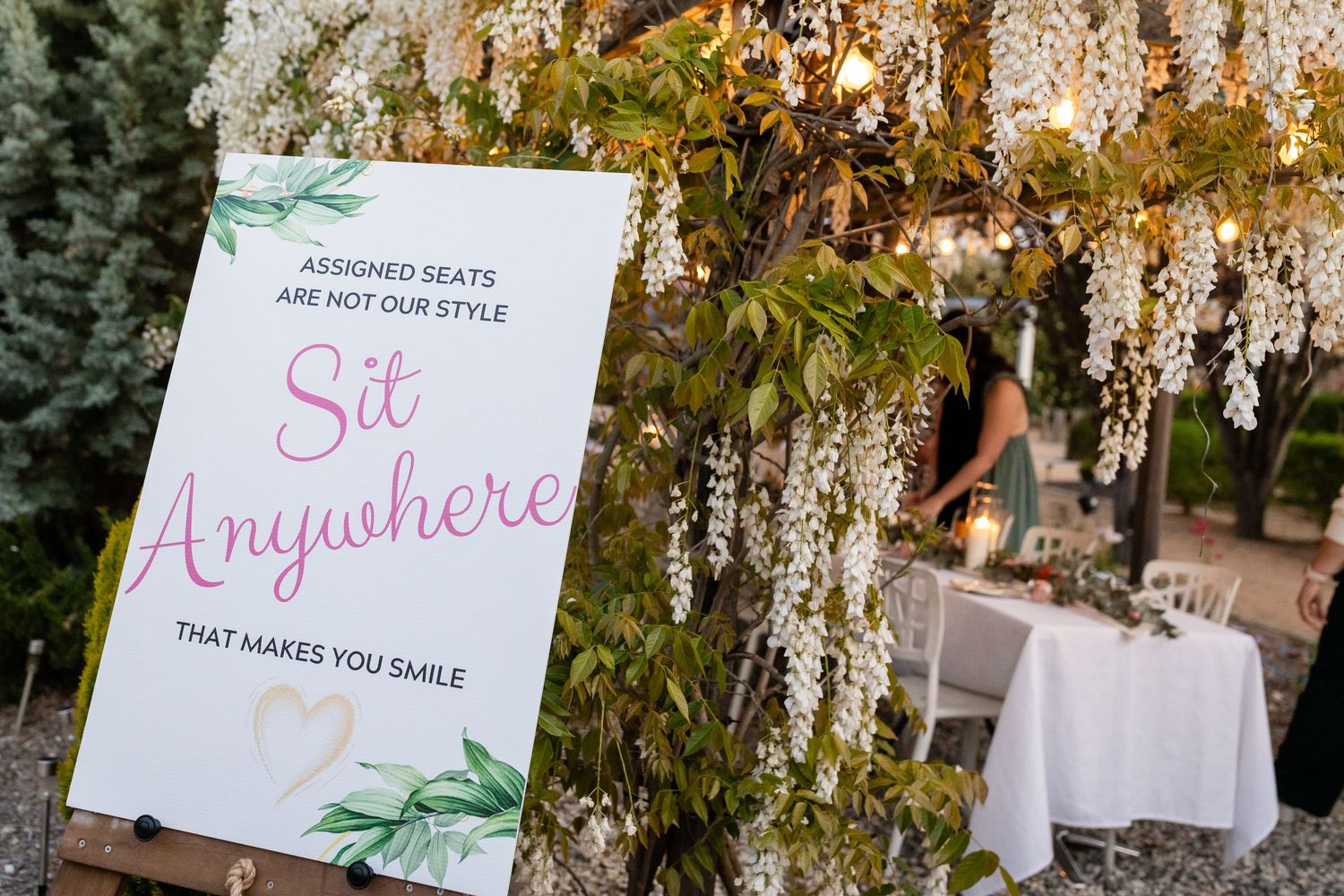 Decorative wedding signage with floral accents and handwritten text.