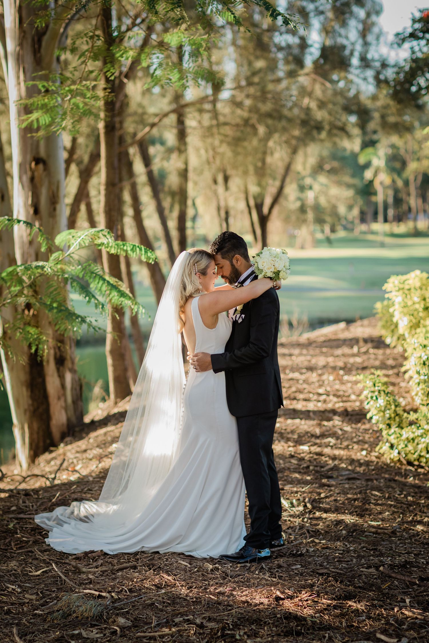 Intimate wedding couple portraits taken in a serene wooded setting. Surfers Paradise Golf Club wedding.
