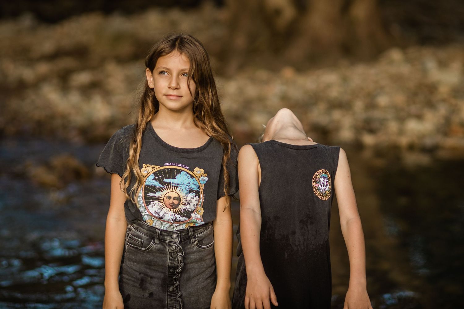 Children in casual summer clothing standing together near water.Gold Coast candid family photographer.