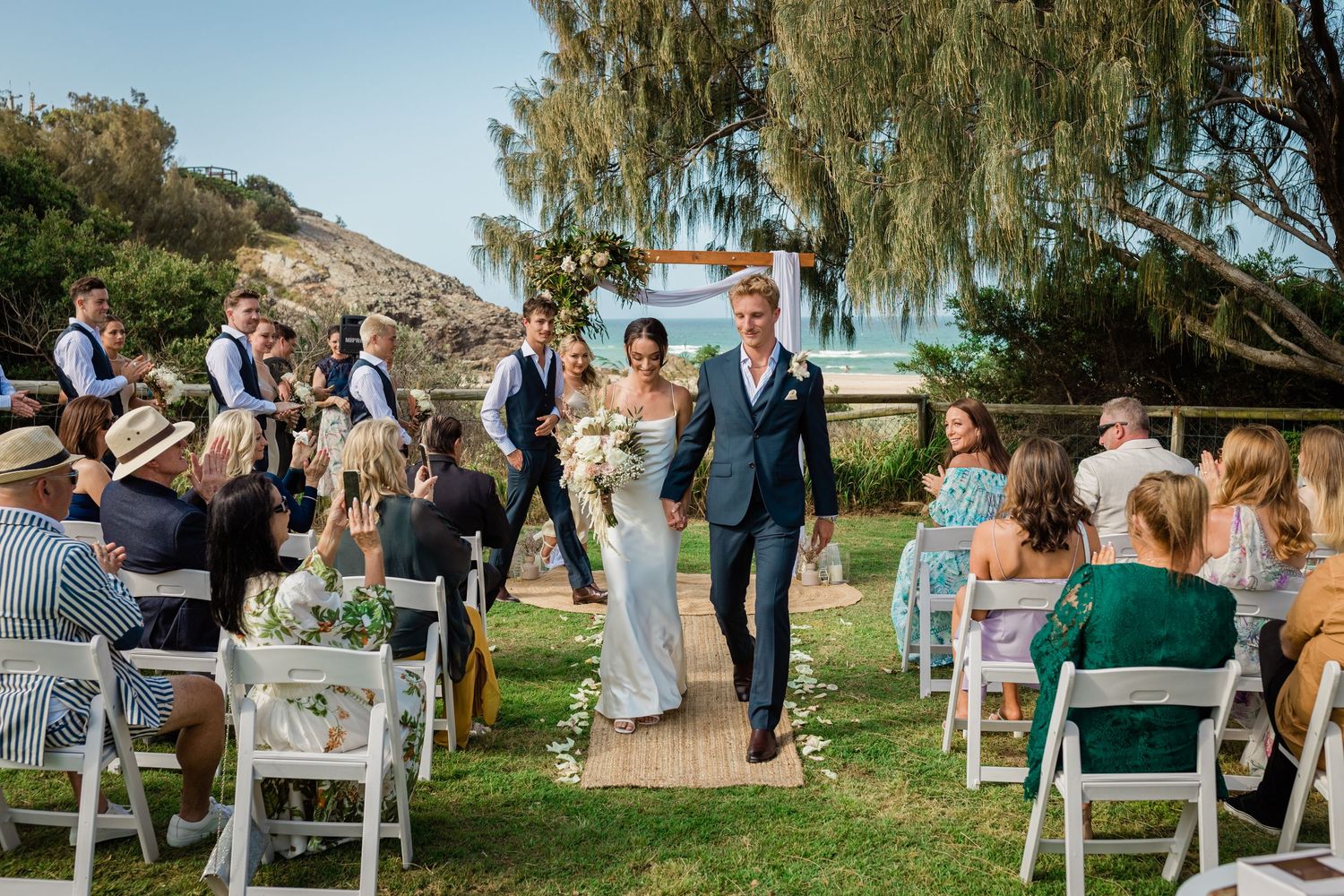 Panoramic view of outdoor wedding ceremony with guests seated under willow trees.Miami Burleigh heads beach wedding