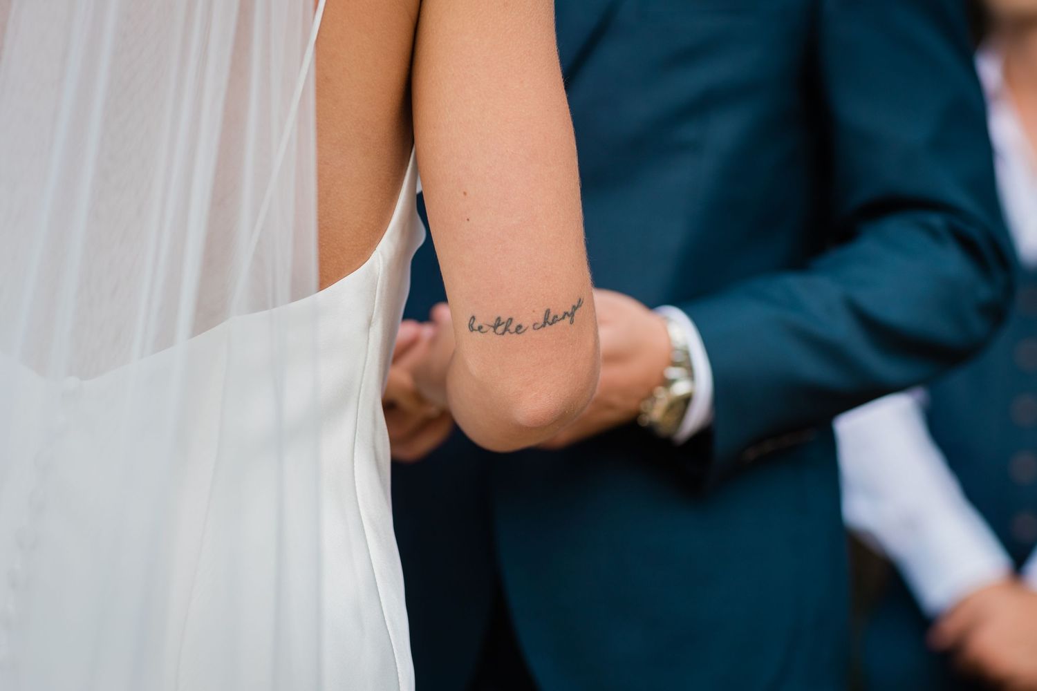 Close-up details of formal wedding attire during ceremony.