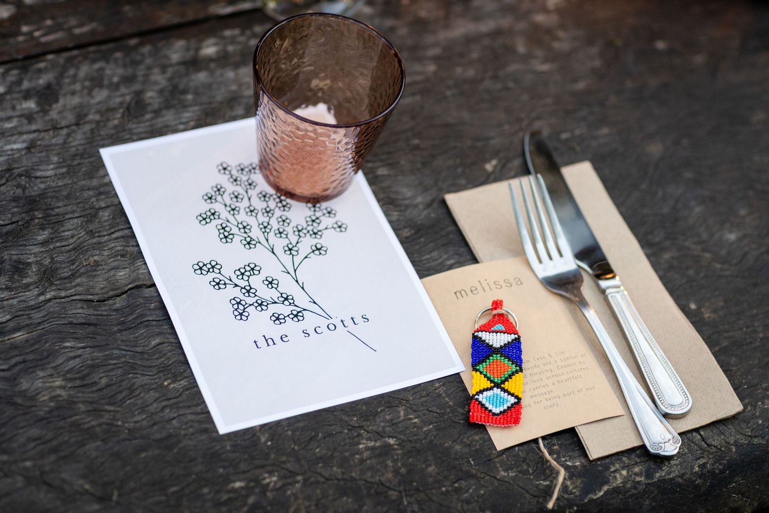 Wedding reception place setting with elegant menu card and gold flatware on dark surface.The barrow restaurant mount Nathan wedding