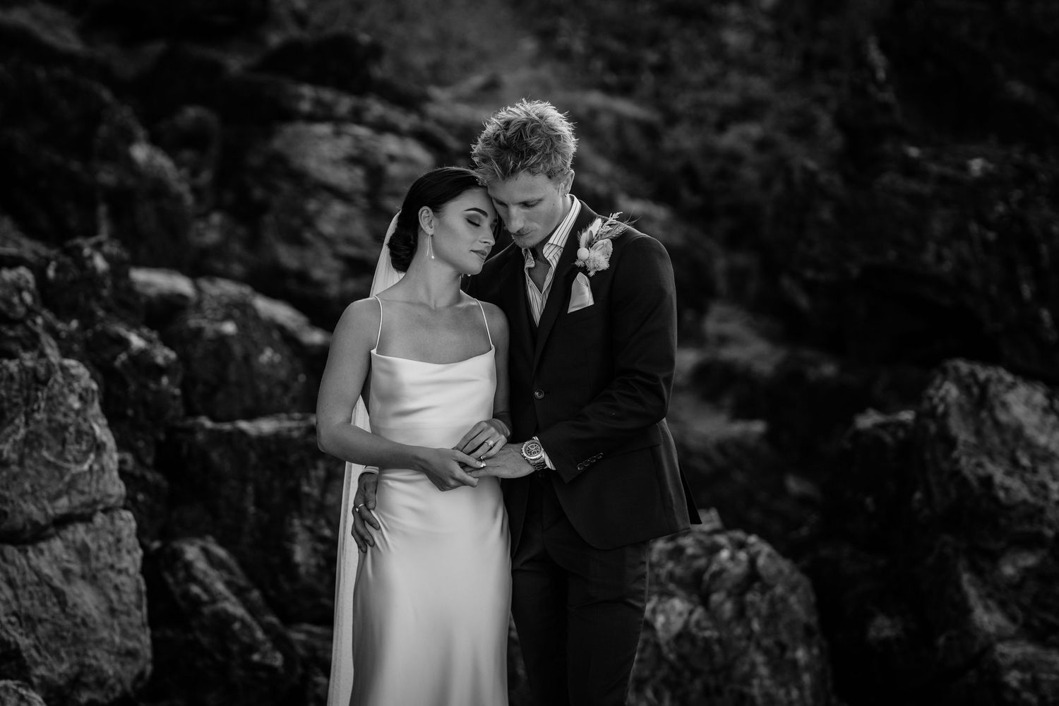 Intimate wedding couple moments captured against dark rocky background. Miami Burleigh heads beach wedding