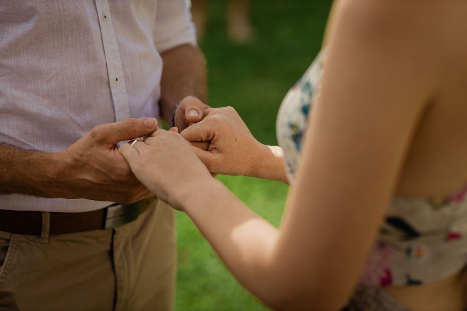 Close-up shot of hands exchanging rings during an intimate wedding ceremony.Gold Coast beach wedding photography