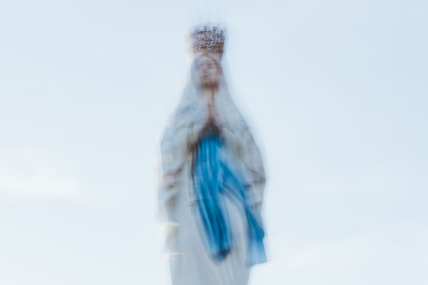 Ethereal photograph of a religious statue with soft focus creating a dreamy effect.