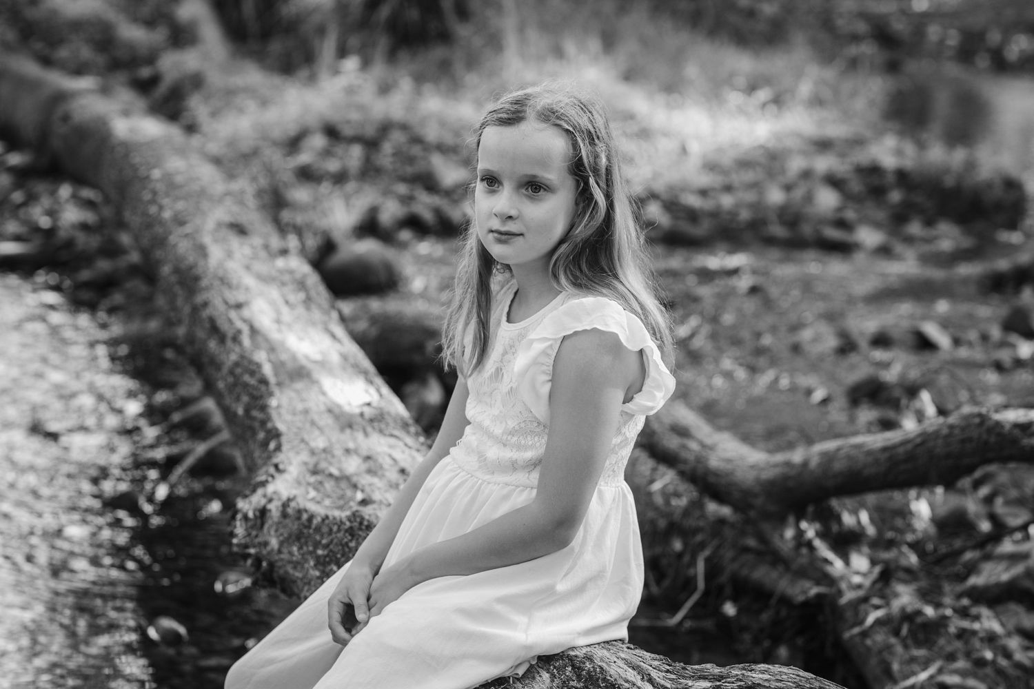 Black and white artistic portraits captured in a natural outdoor setting among rocks and trees.Tallebudgera family photography. Gold Coast