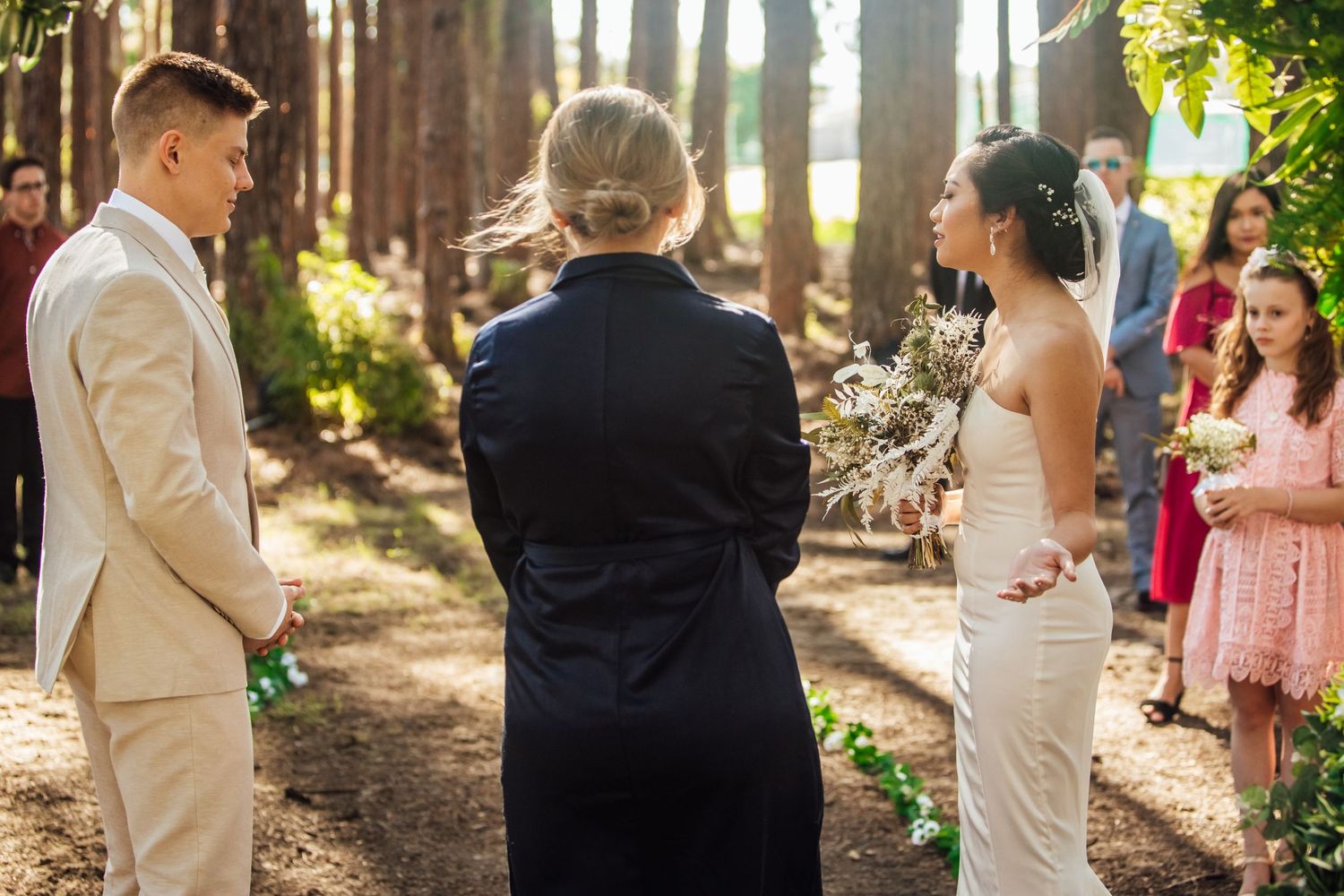 Intimate wedding gathering in a wooded setting with guests watching the ceremony.pizzey park wedding Gold Coast