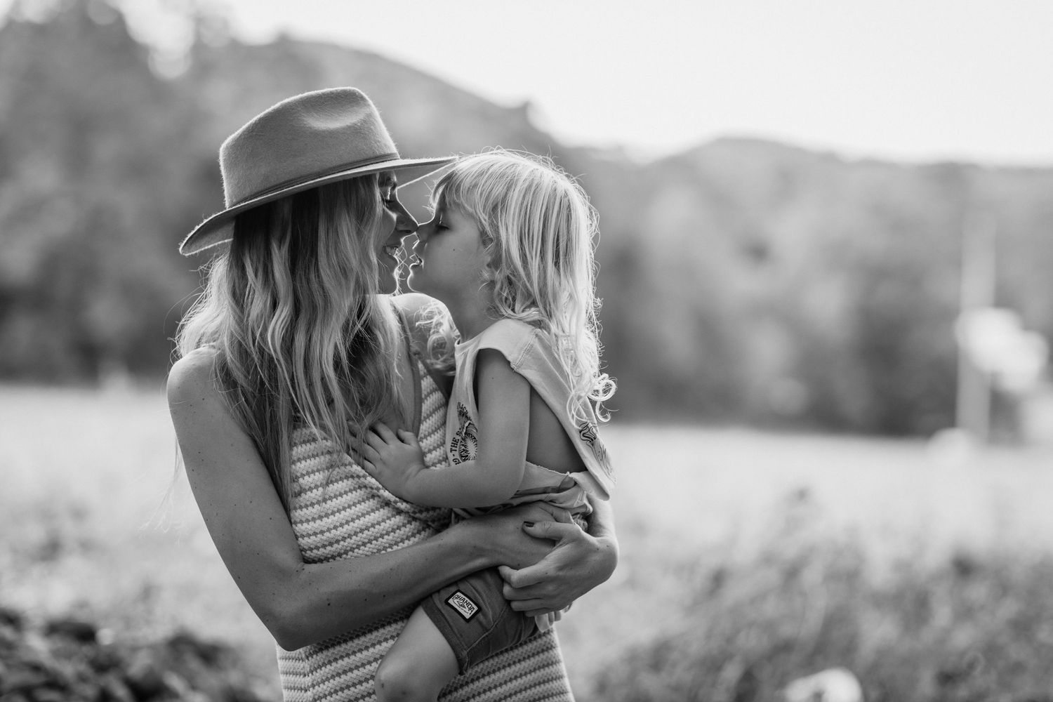 Candid black and white photo capturing intimate family moments outdoors.Gold Coast family photographerGold Coast candid family photographer.