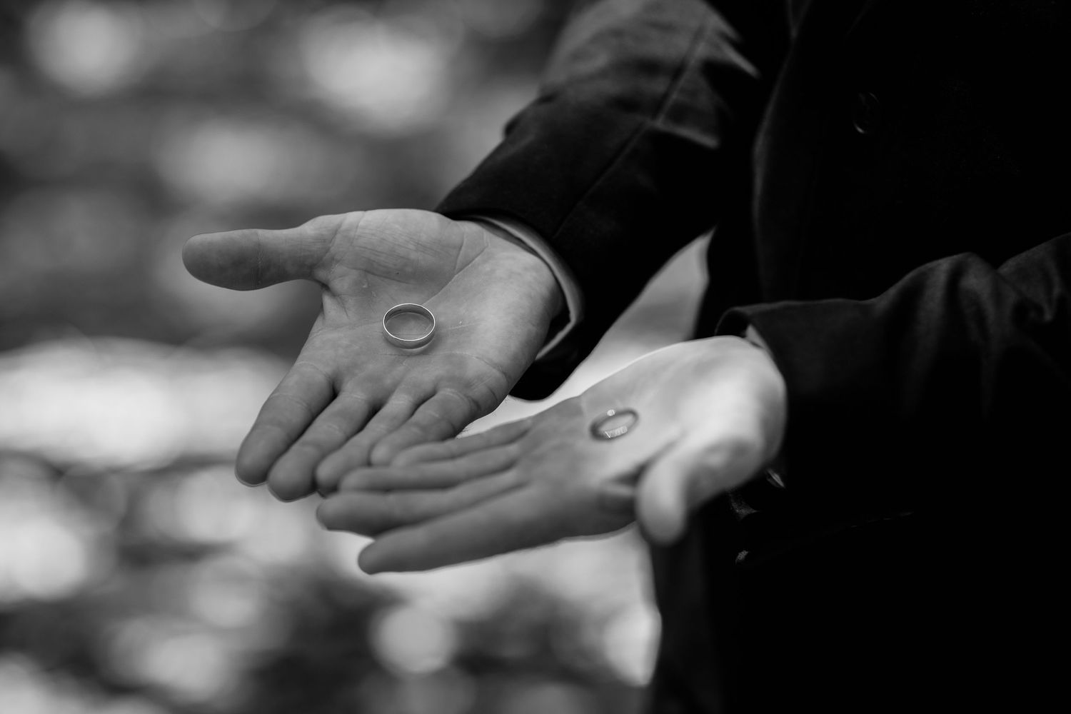 Close-up black and white shot of wedding rings being exchanged.Currumbin Valley wedding photography Gold Coast