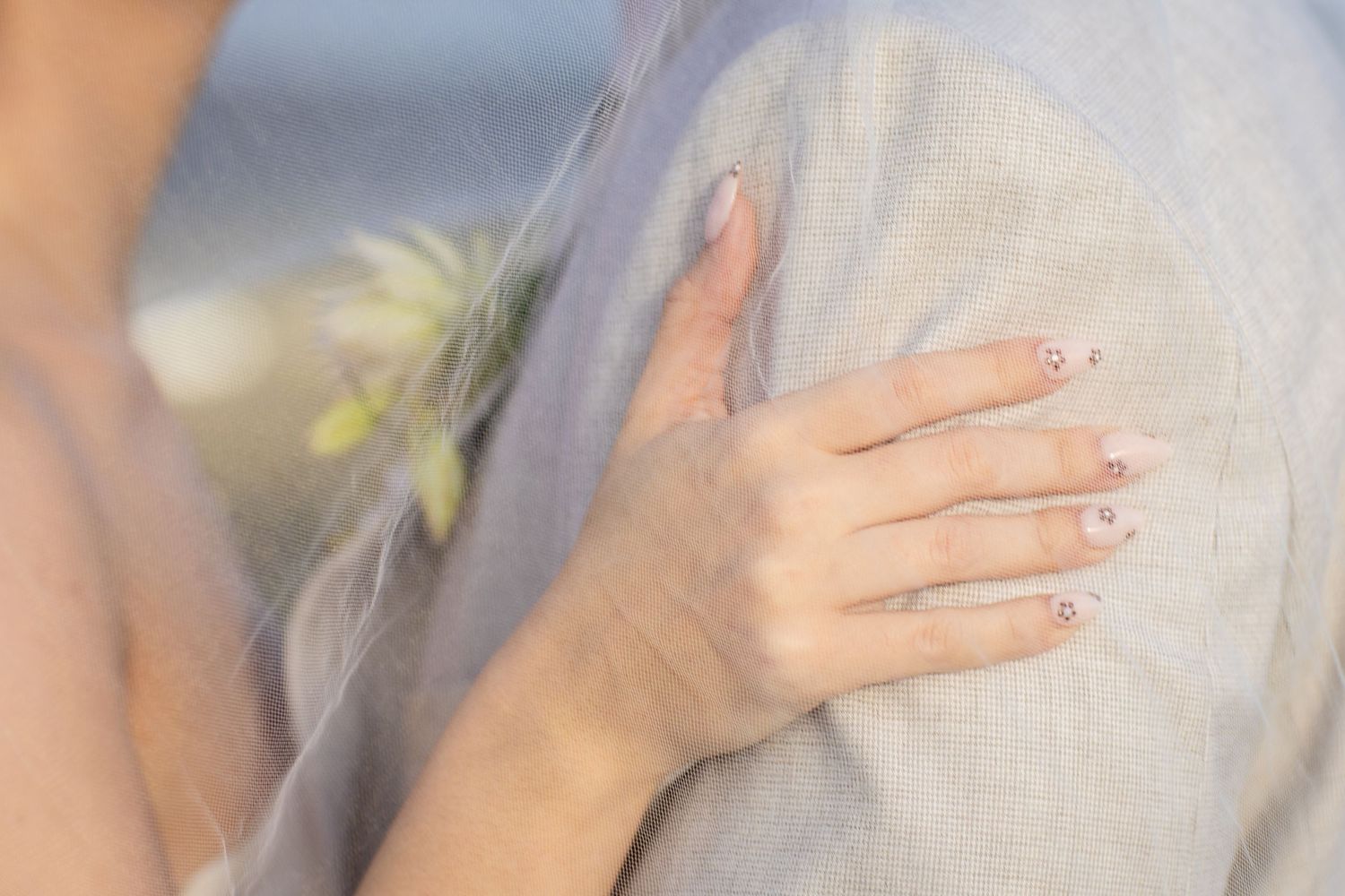 Close-up details of delicate white wedding veil and dress in natural lighting.The barrow restaurant mount Nathan wedding