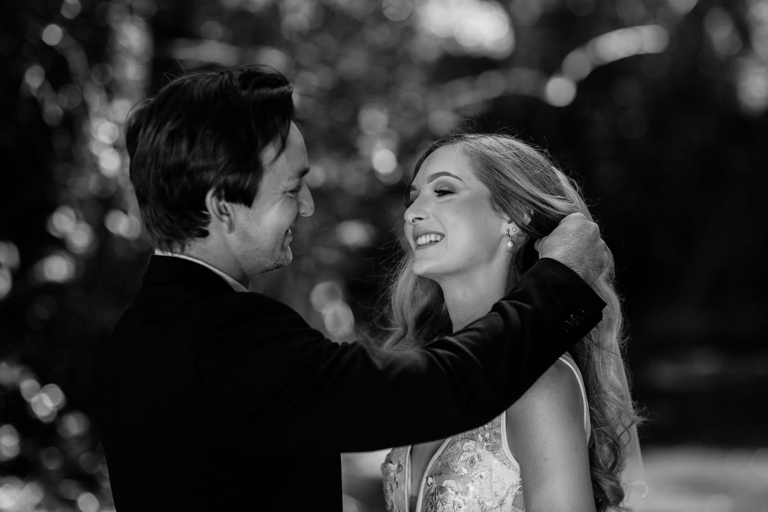 Black and white portrait captures joyful wedding couple moments in natural setting.Currumbin Valley wedding photography Gold Coast