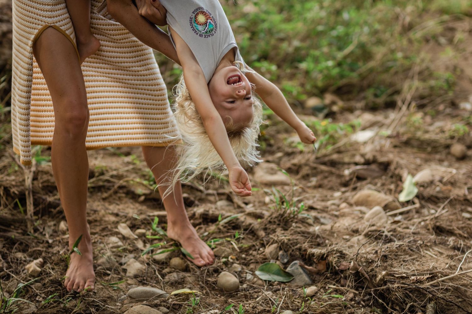 People walking along a natural dirt path through wooded area.Gold Coast family photographer. Gold Coast candid family photographer.