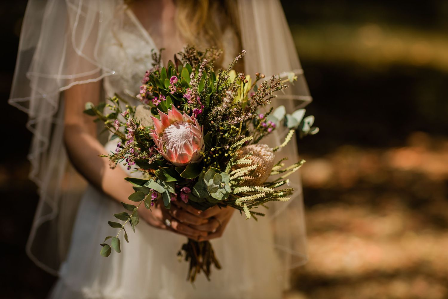 Rustic wedding bouquet with wildflowers and greenery in natural outdoor setting. Currumbin Valley wedding photography Gold Coast wedding