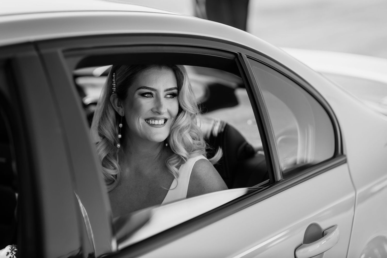 Joyful moments captured through car windows during wedding transportation. Surfers Paradise Golf Club wedding.