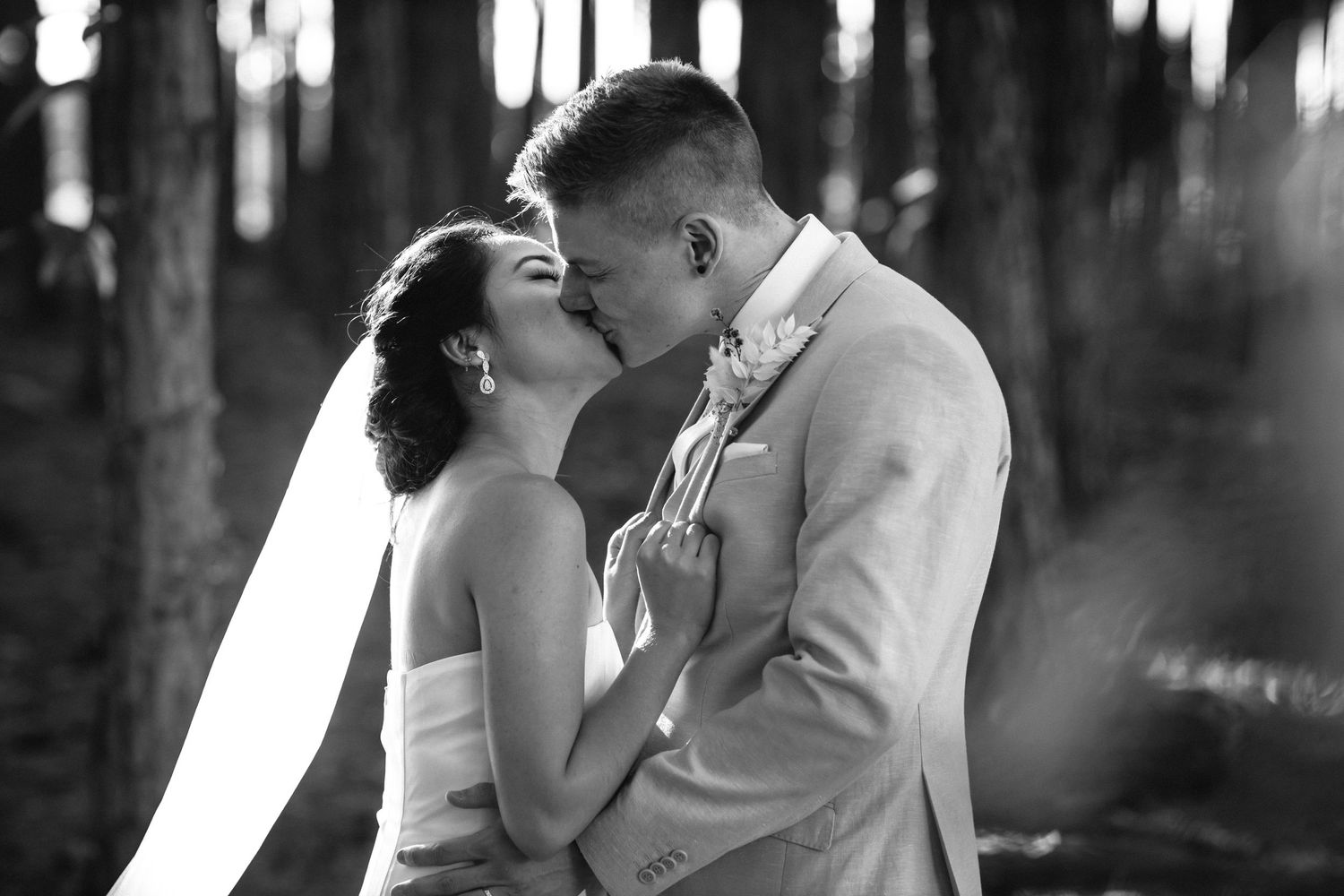 Black and white portrait captures tender embrace between couple in forest.pizzey park wedding Gold Coast