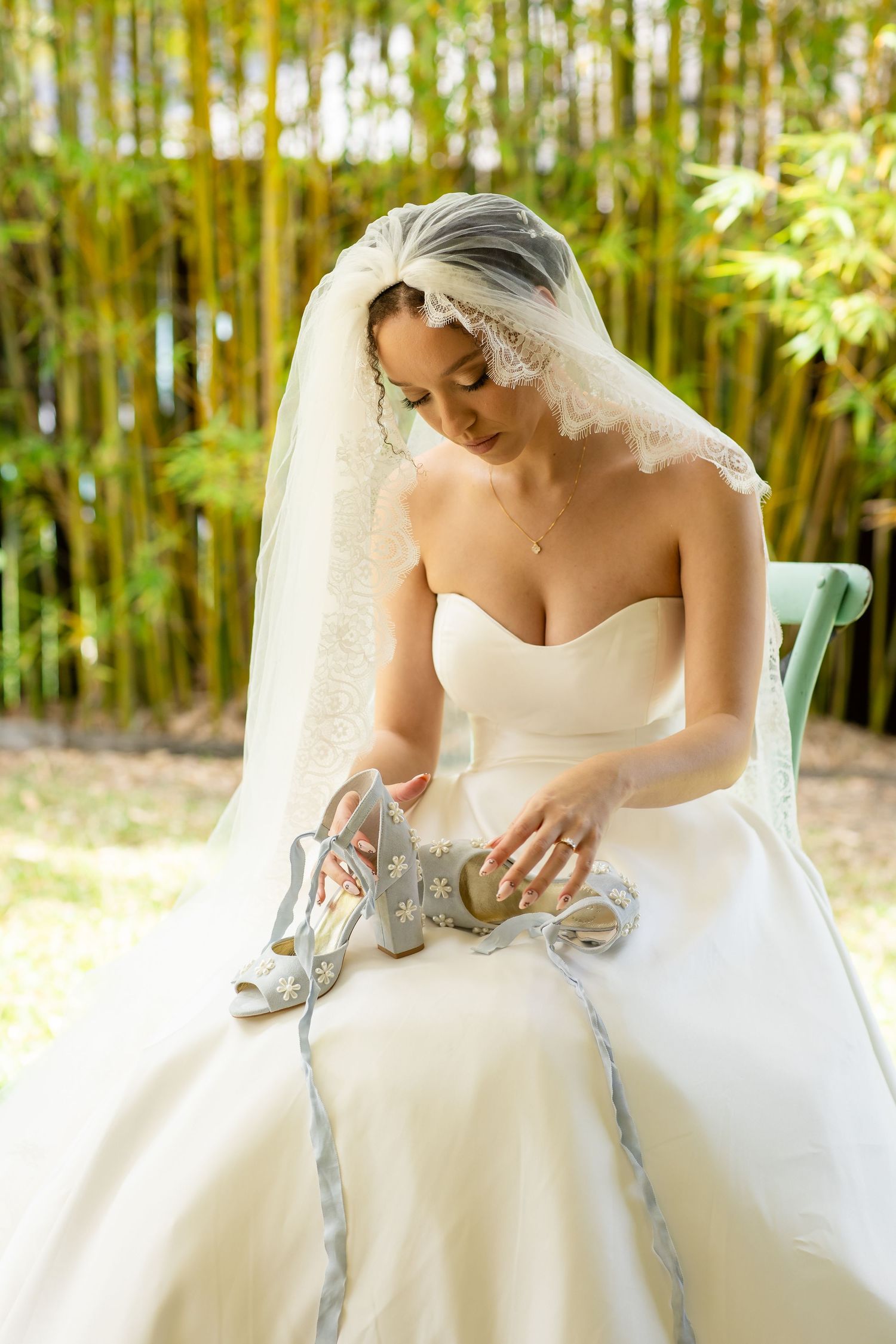 Close-up details of a bride's dress and silver shoes against bamboo garden backdrop.Gold Coast hinterland wedding photographer