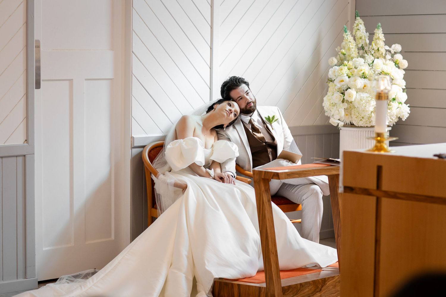 Candid wedding ceremony moments unfold in a bright white chapel interior.Gold Coast hinterland wedding photographer