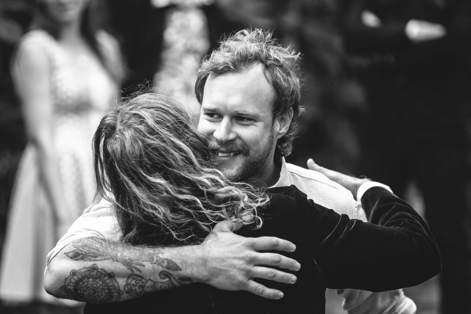 Black and white candid shots of joyful embraces and interactions.