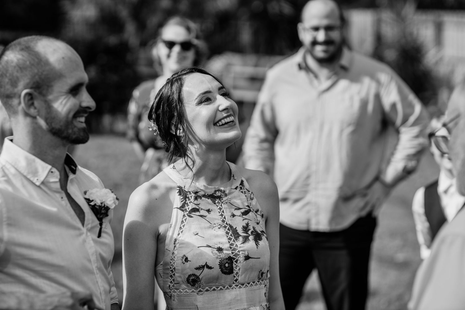 Guests mingle and socialize during an outdoor garden wedding reception.