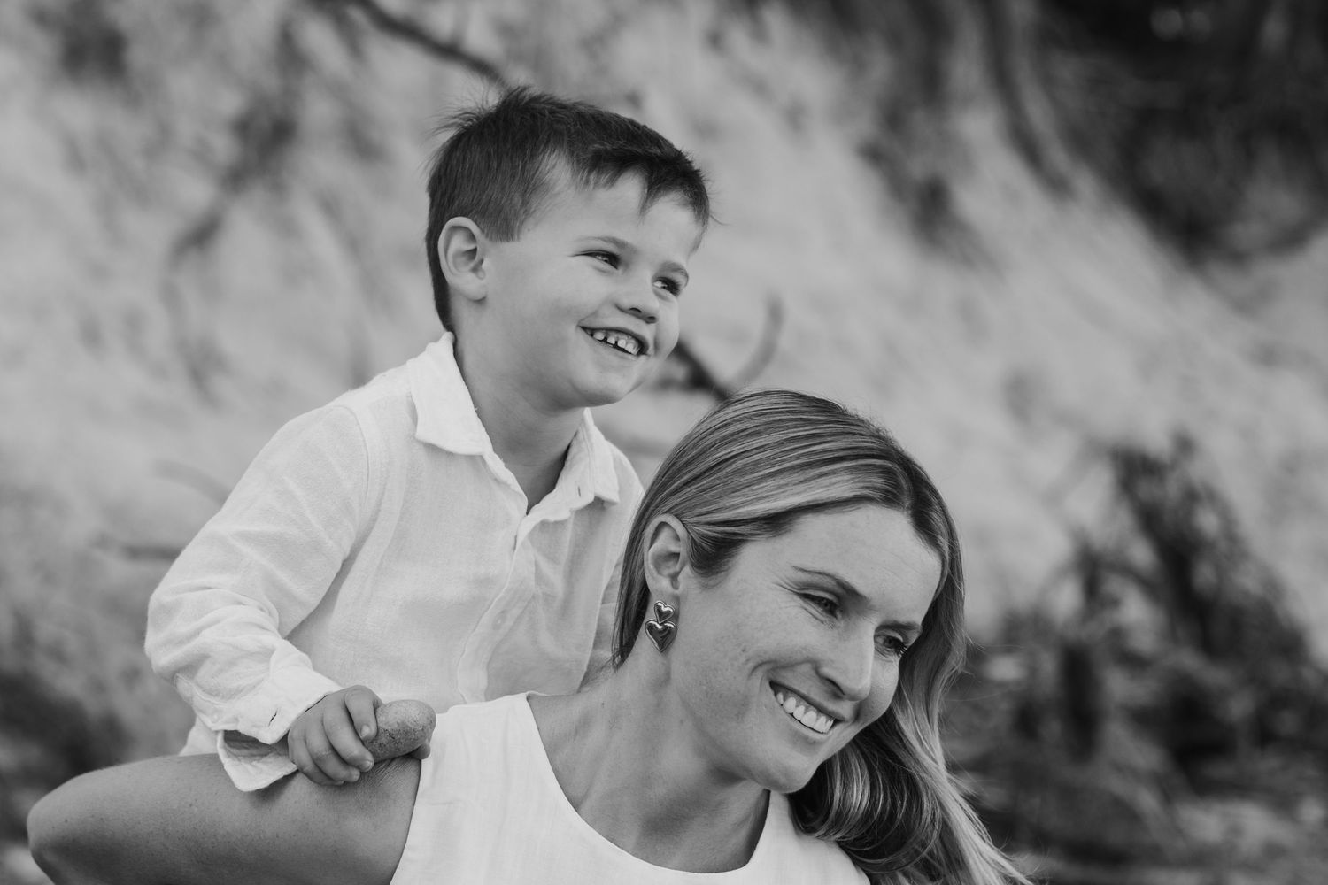 Joyful candid black and white portrait session at the beach with natural expressions and laughter.Cabarita headland