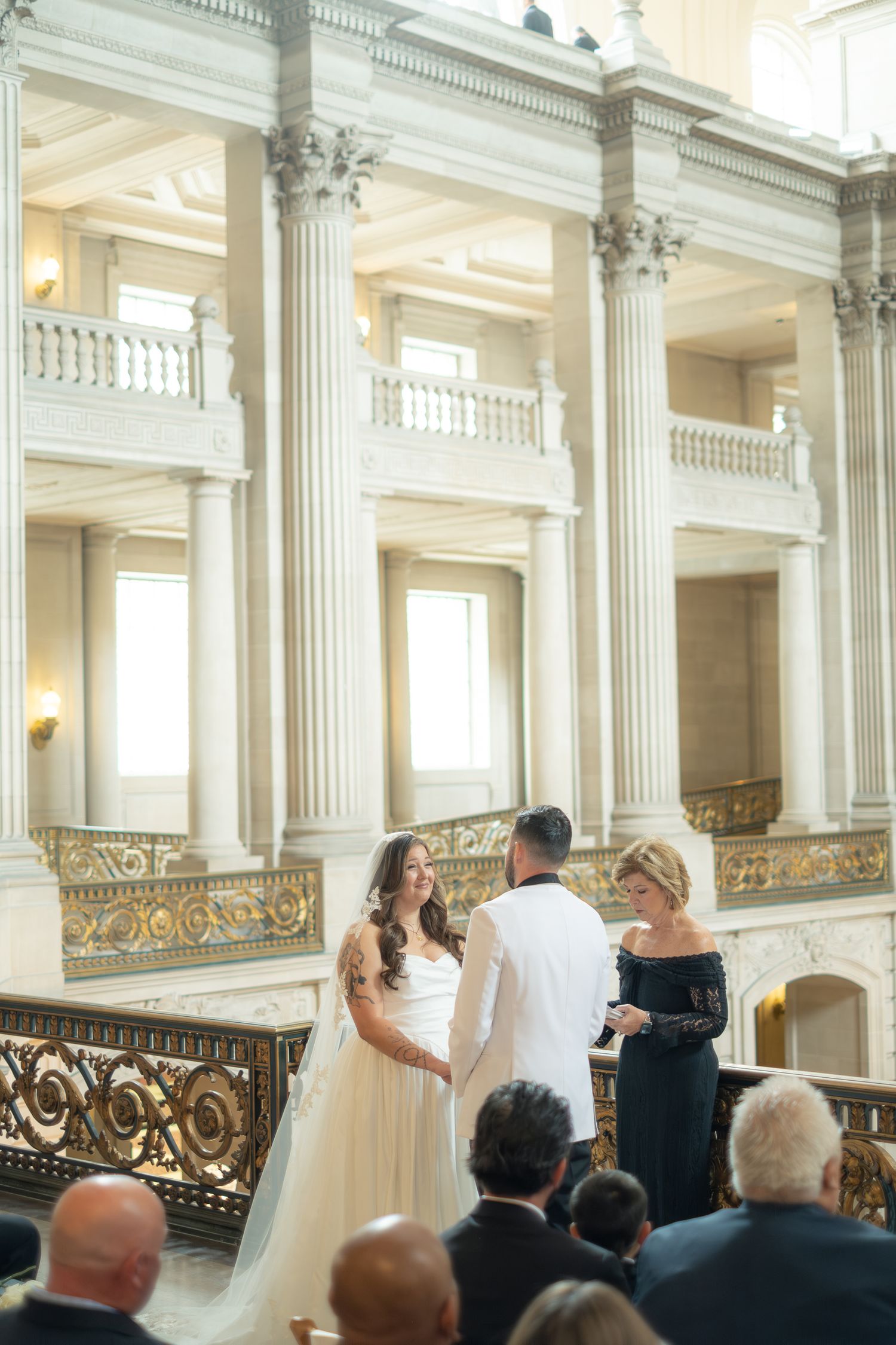 Bride and groom exchange vows at an elegant San Francisco City Hall wedding ceremony.