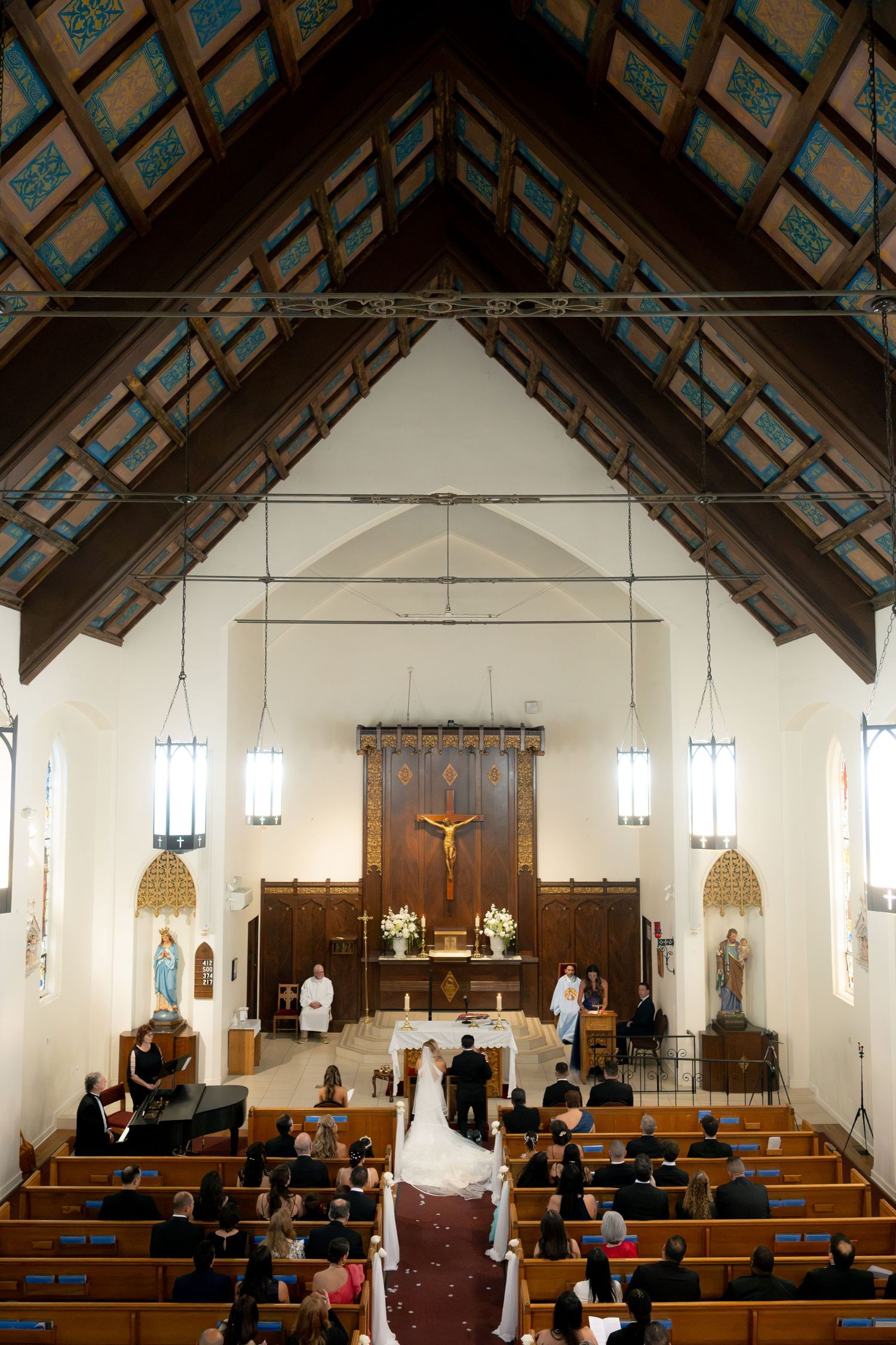 Aerial view of traditional church wedding ceremony with bride and groom at the altar.