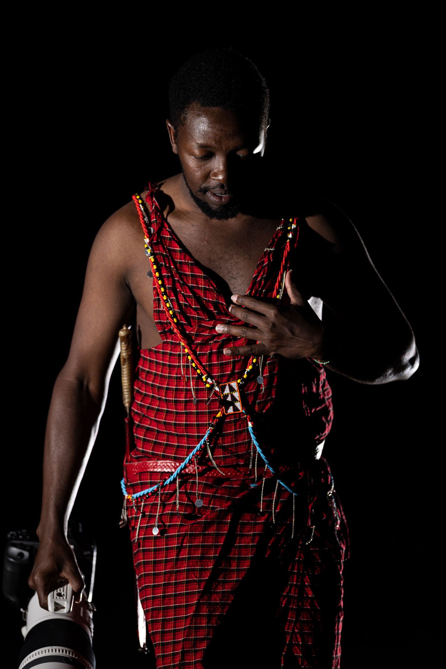 Performer in red checkered tank top with black background shown in multiple cropped views during dramatic performance.