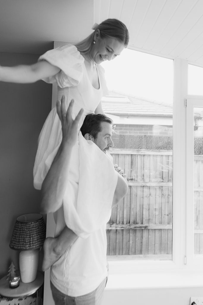 Monochrome image sequence showing a graceful dance lift against a bright window.