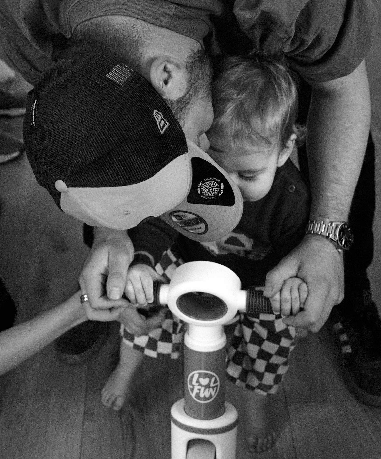 Black and white image showing hands pouring coffee in a casual setting.