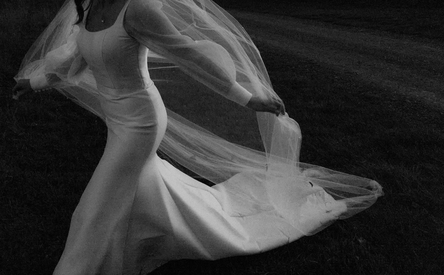 A flowing white dress billows dramatically in a series of black and white motion shots.