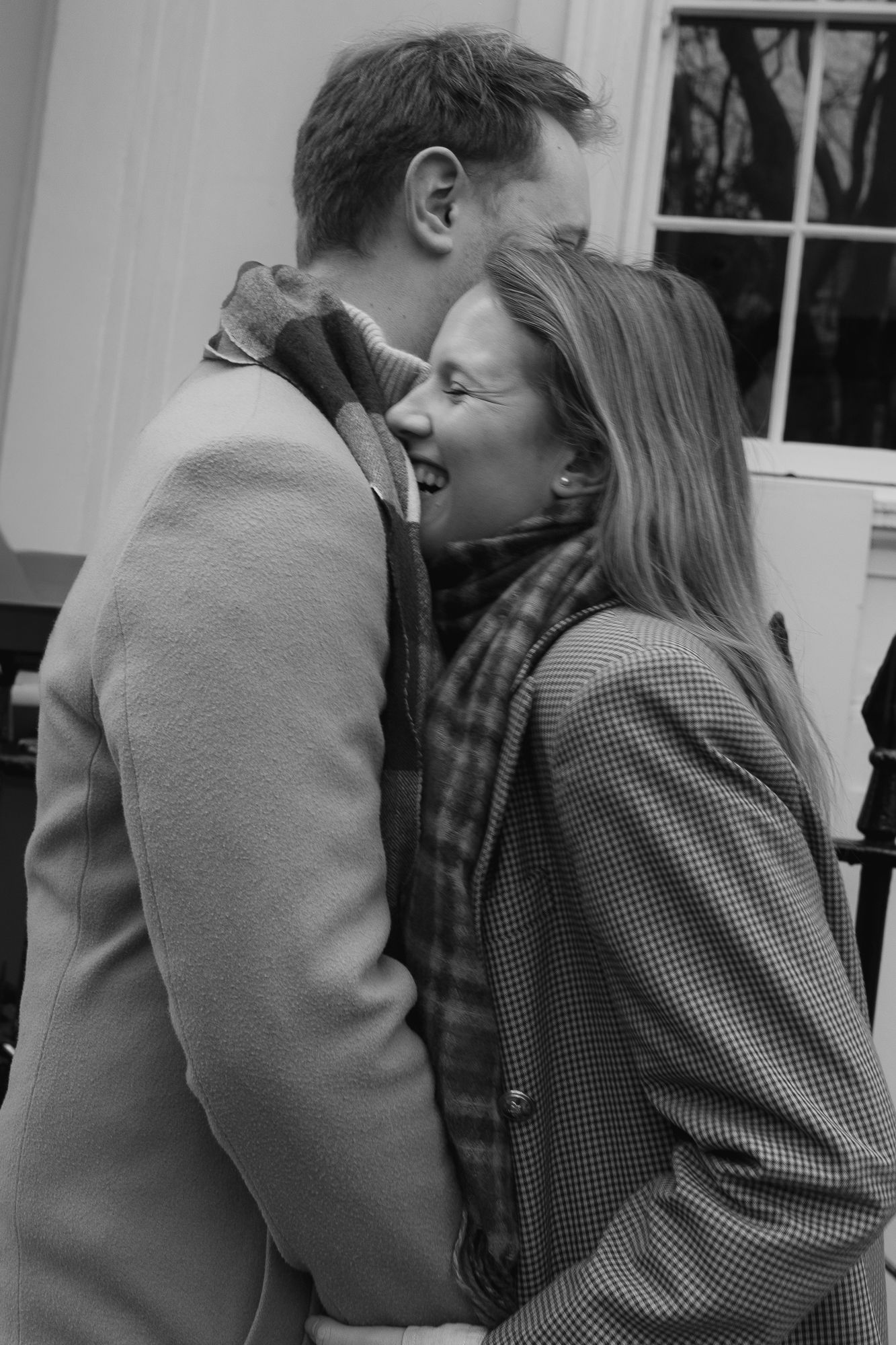 Black and white photos capturing intimate moments between two people in winter attire.